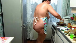Chubby milf cooks pies and fucks with a wooden pestle in the kitchen. Her juicy PAWG and big tits are shaking. Homemade fetish. Does your wife make dinner naked?